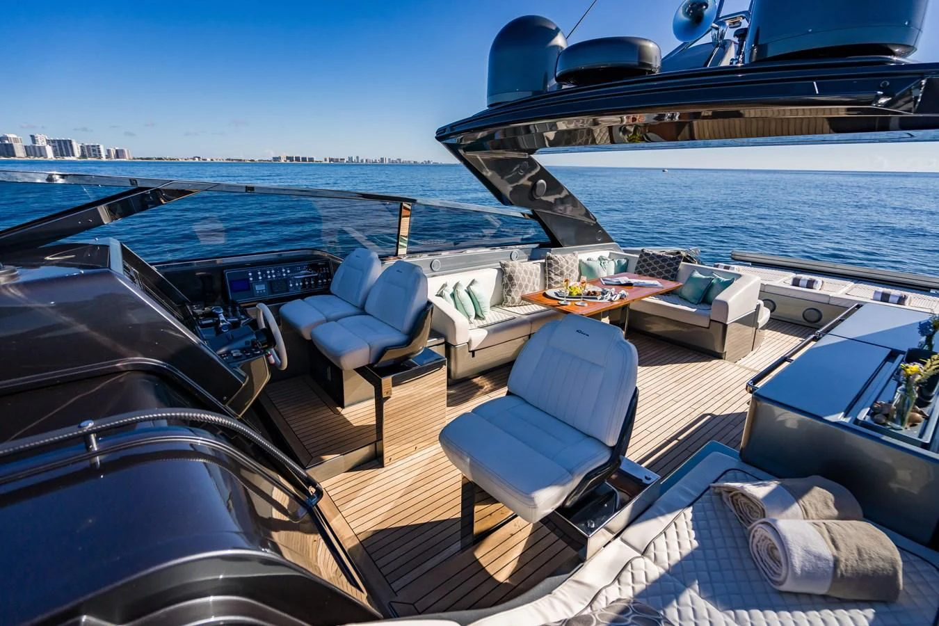 a deck with a view of the ocean and a large cruise ship aboard BABY PEARL Yacht for Sale