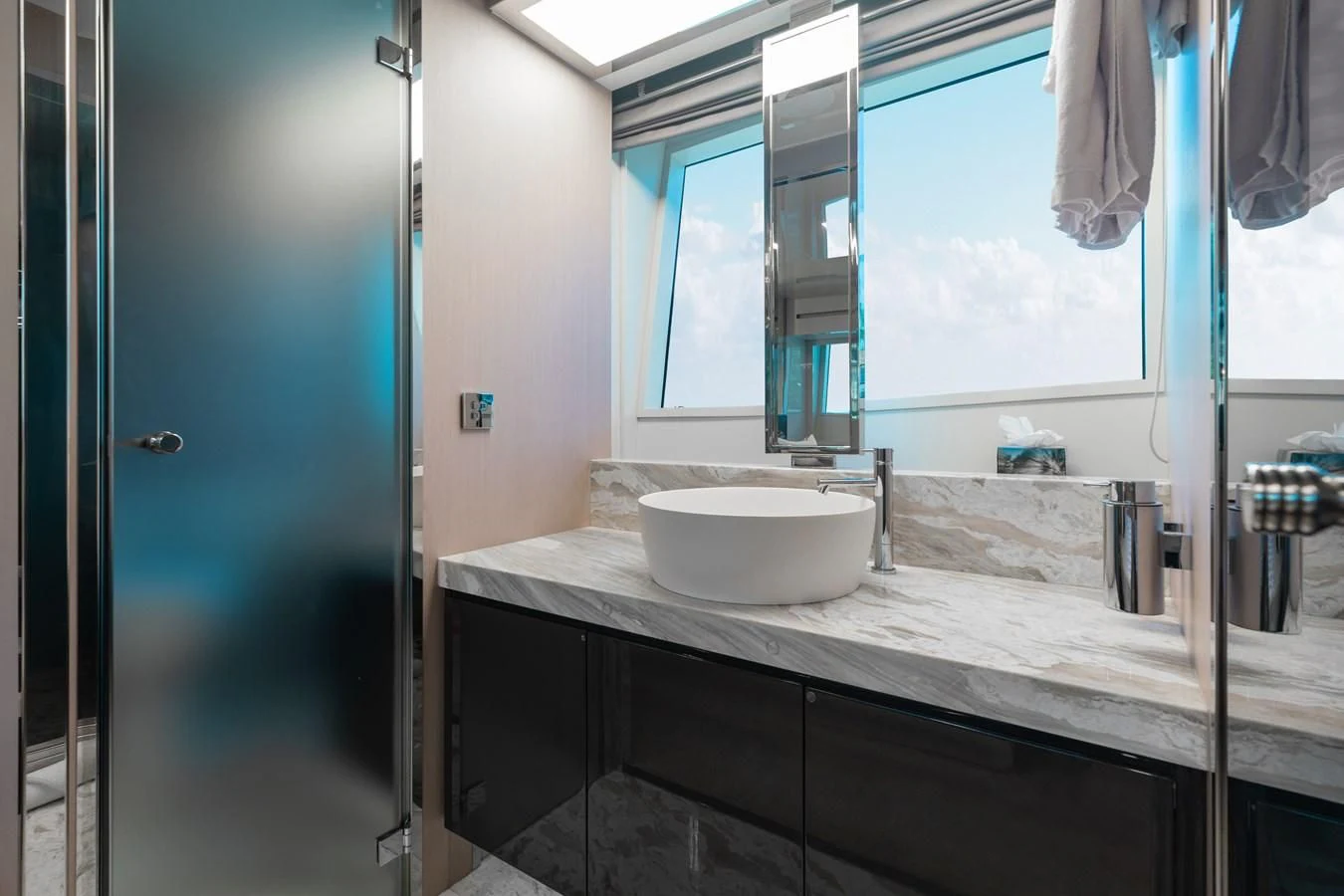 a bathroom with a sink and a window aboard BABY PEARL Yacht for Sale