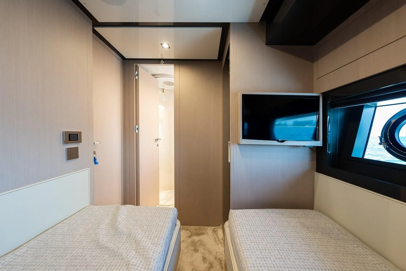 a bedroom with a bed and a tv on the wall aboard BABY PEARL Yacht for Sale