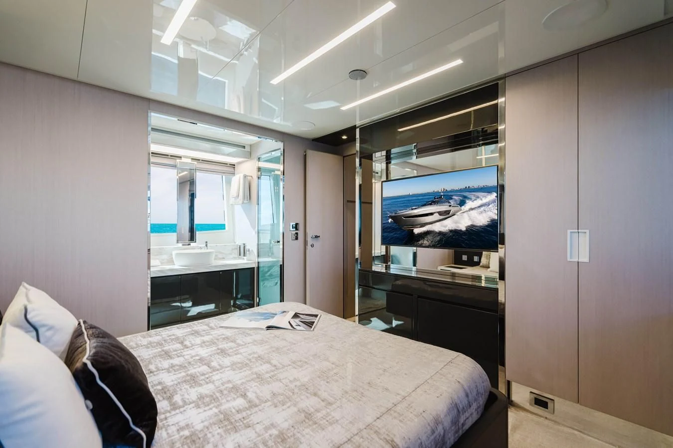 a bedroom with a bed and a desk aboard BABY PEARL Yacht for Sale