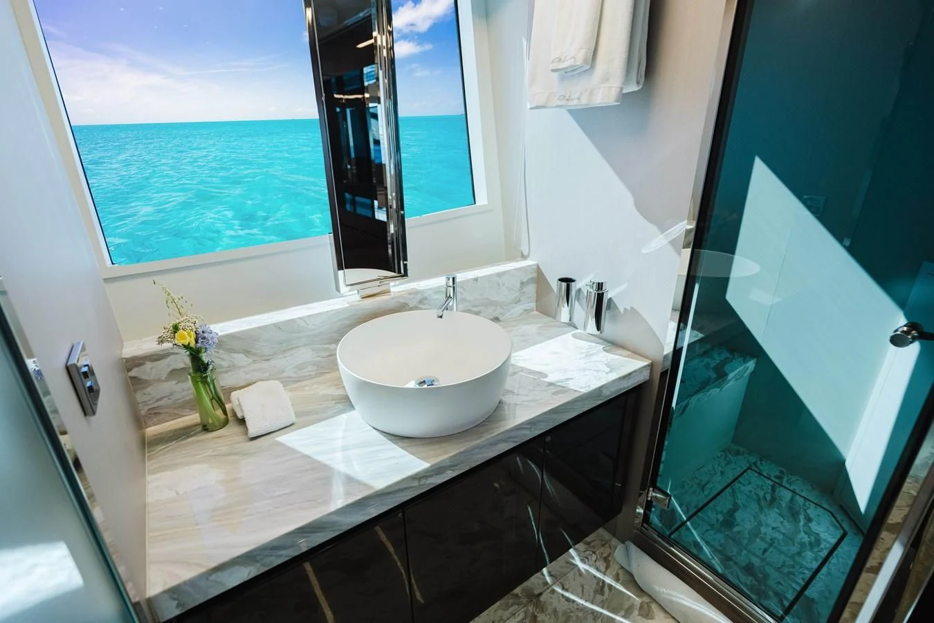 a bathroom with a sink and a large window aboard BABY PEARL Yacht for Sale