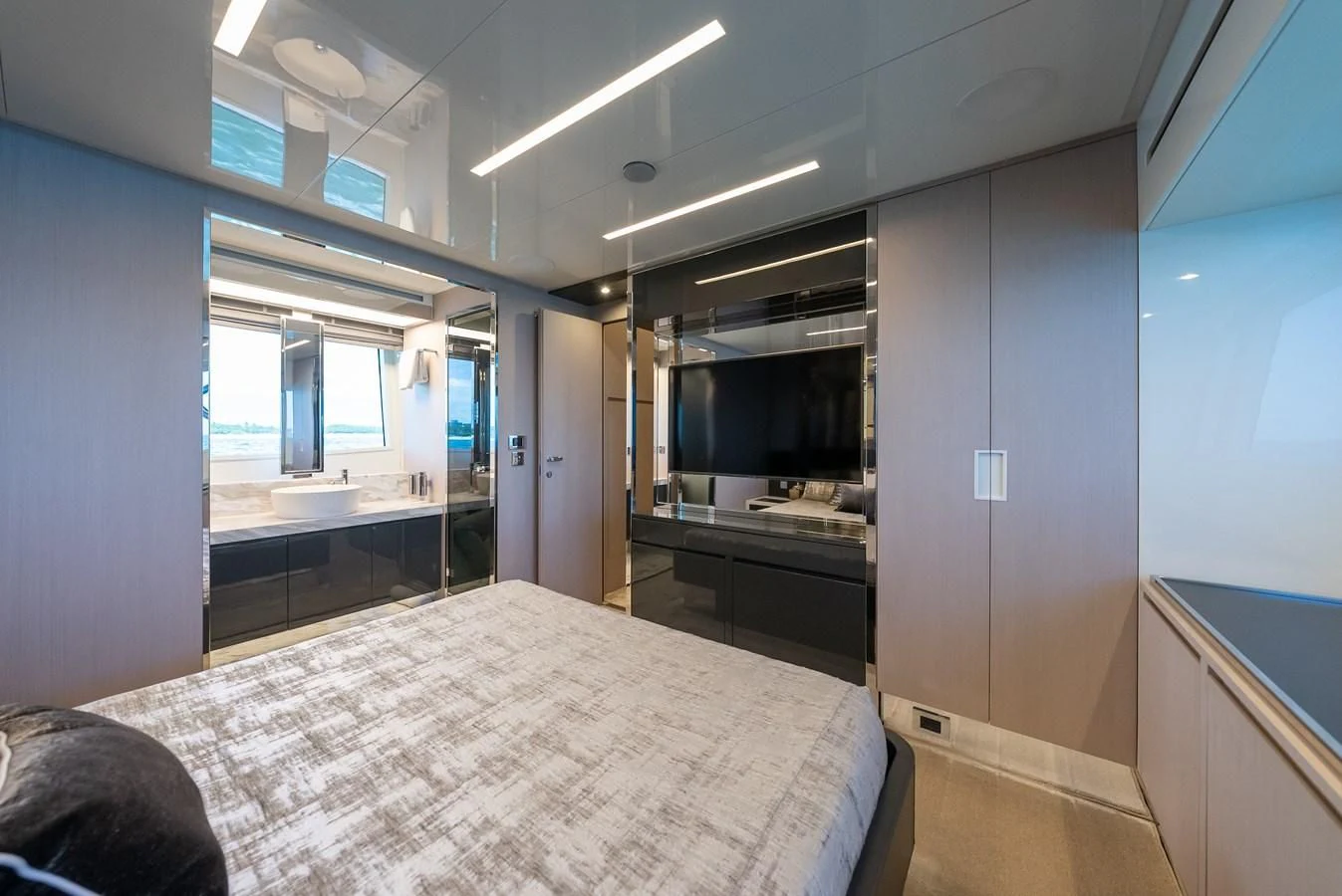 a bedroom with a bed and a desk aboard BABY PEARL Yacht for Sale