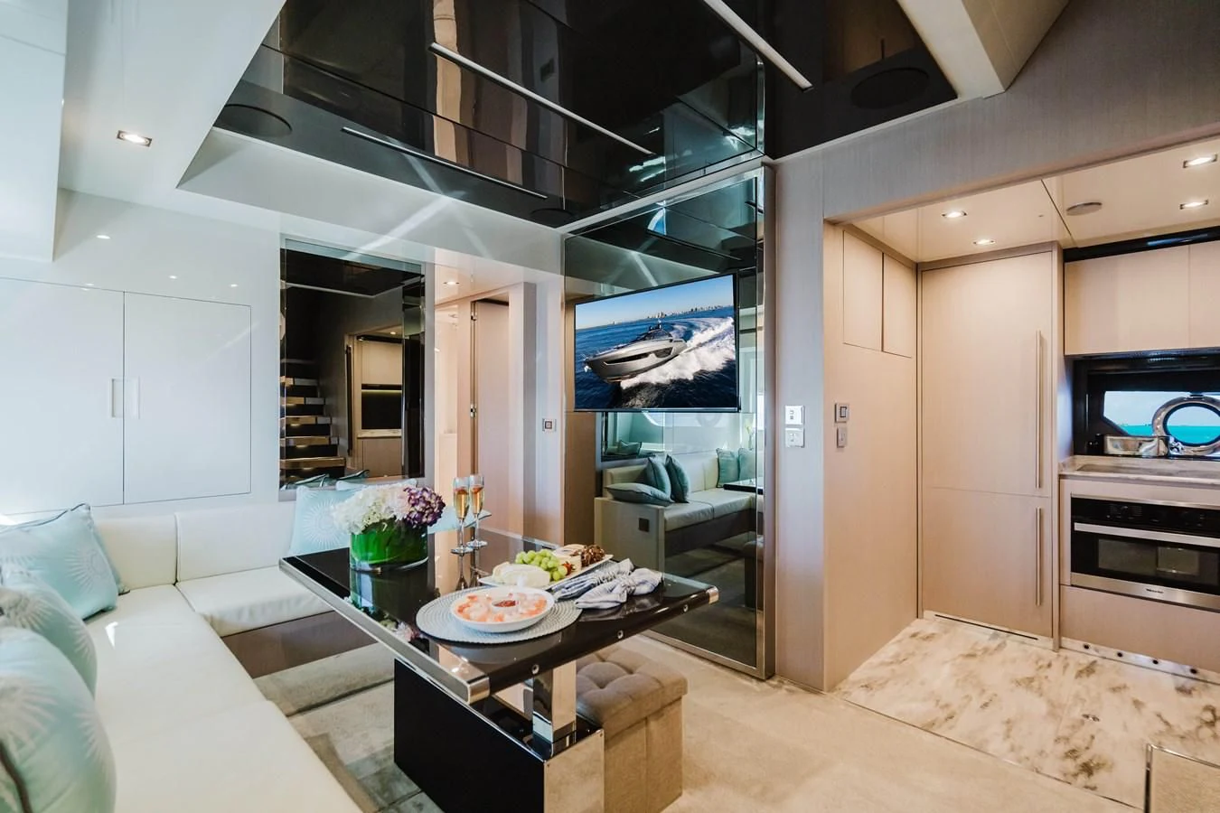 a living room with a table and couches aboard BABY PEARL Yacht for Sale