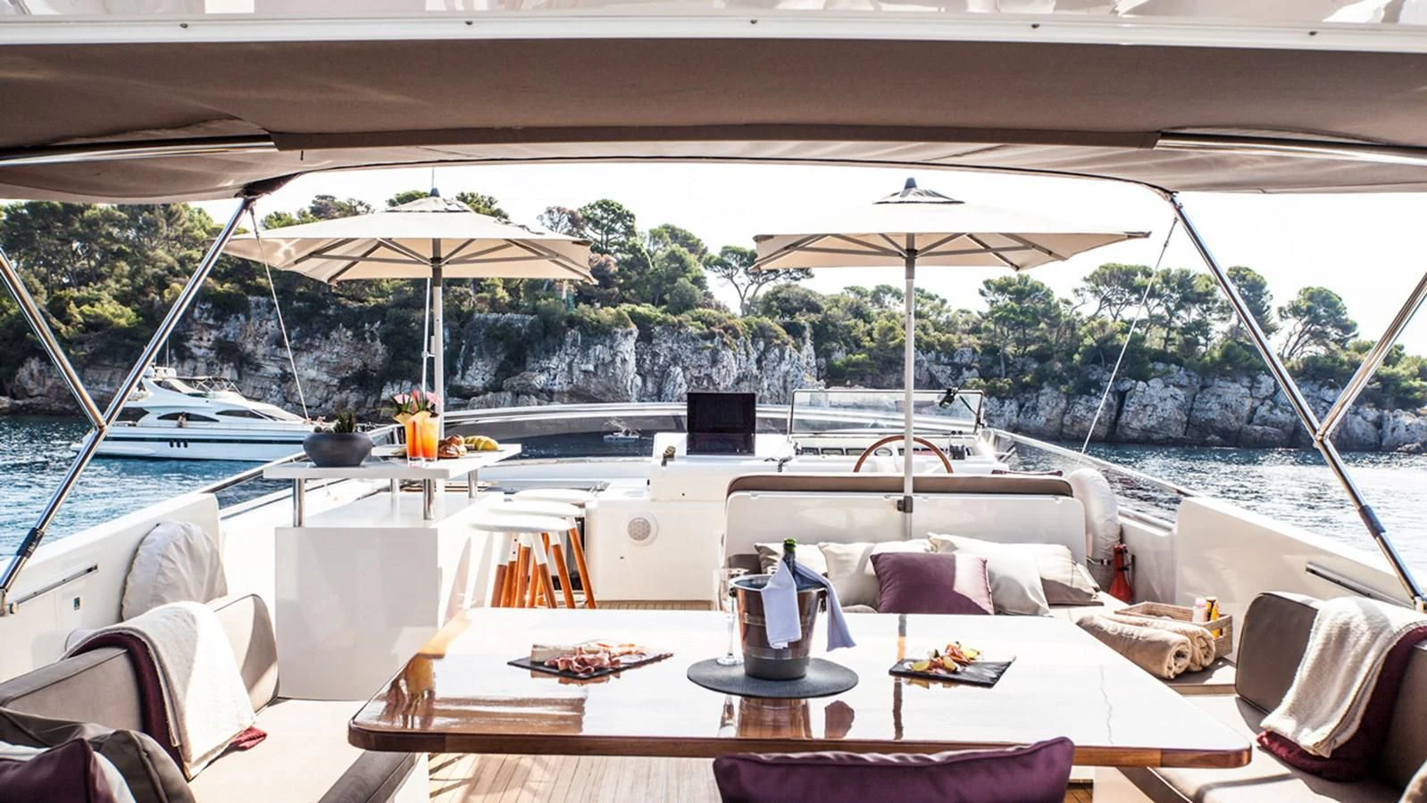 a table with chairs and umbrellas on it aboard SOLAL Yacht for Sale