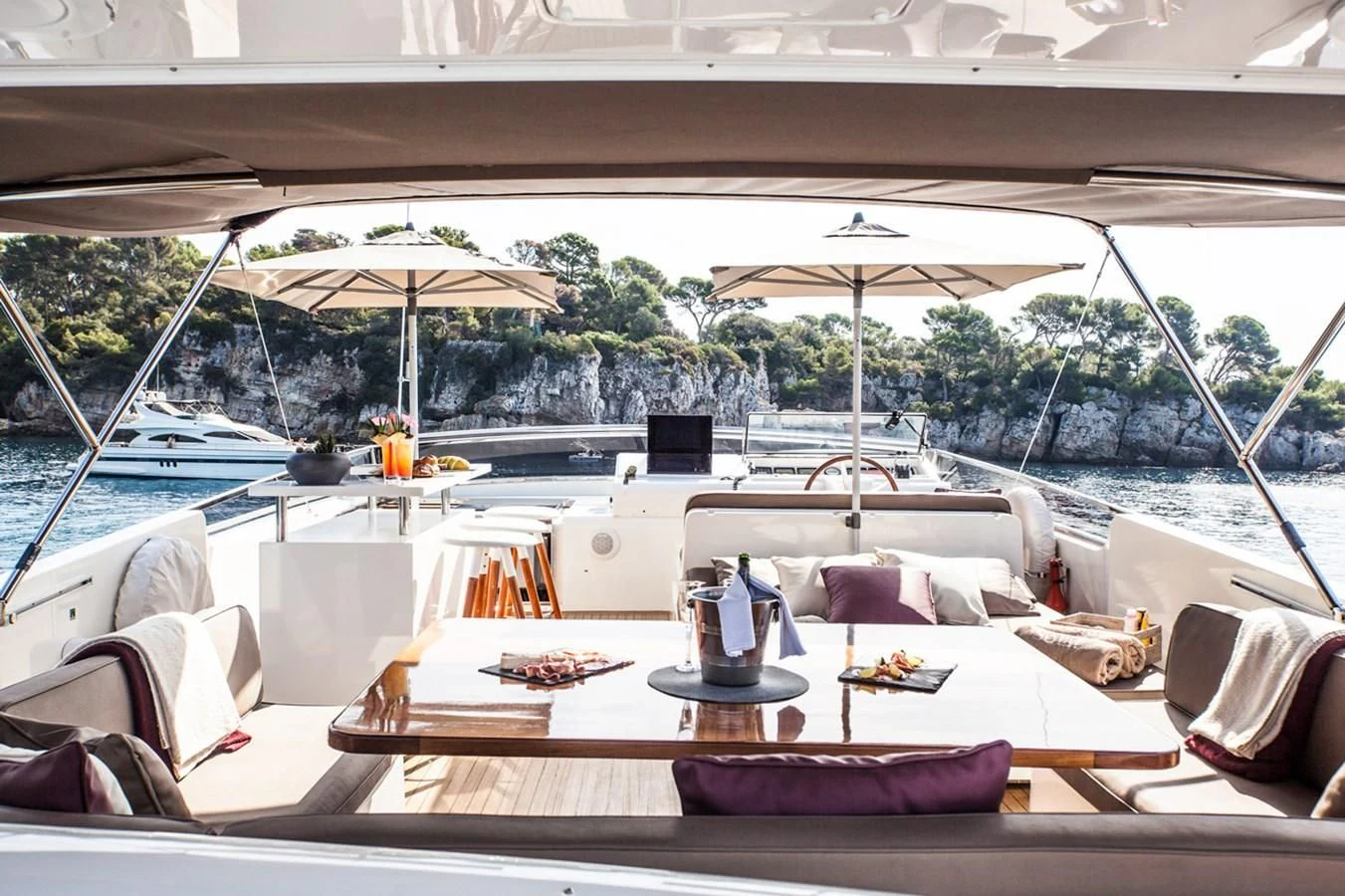 a table with chairs and umbrellas on it aboard SOLAL Yacht for Sale