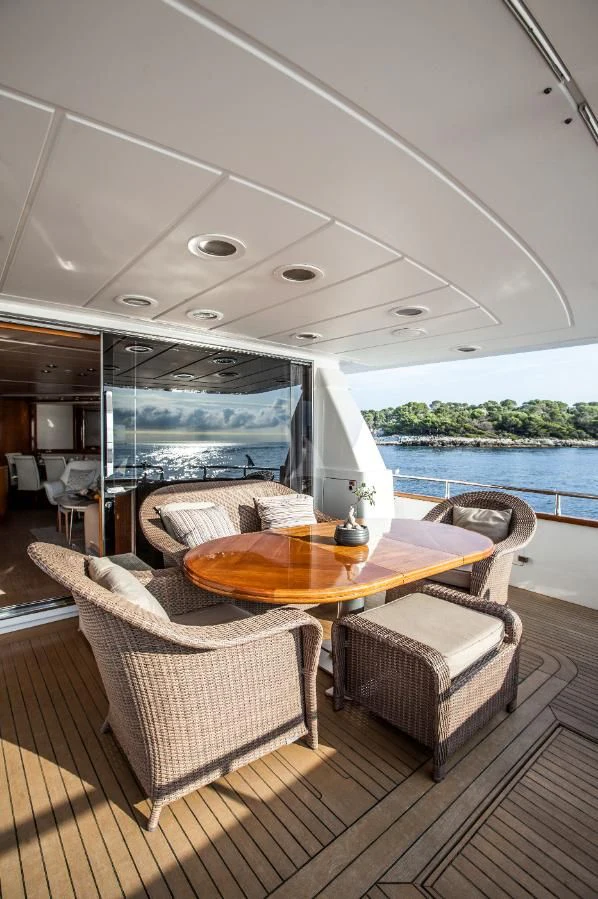 a table and chairs on a deck aboard SOLAL Yacht for Sale