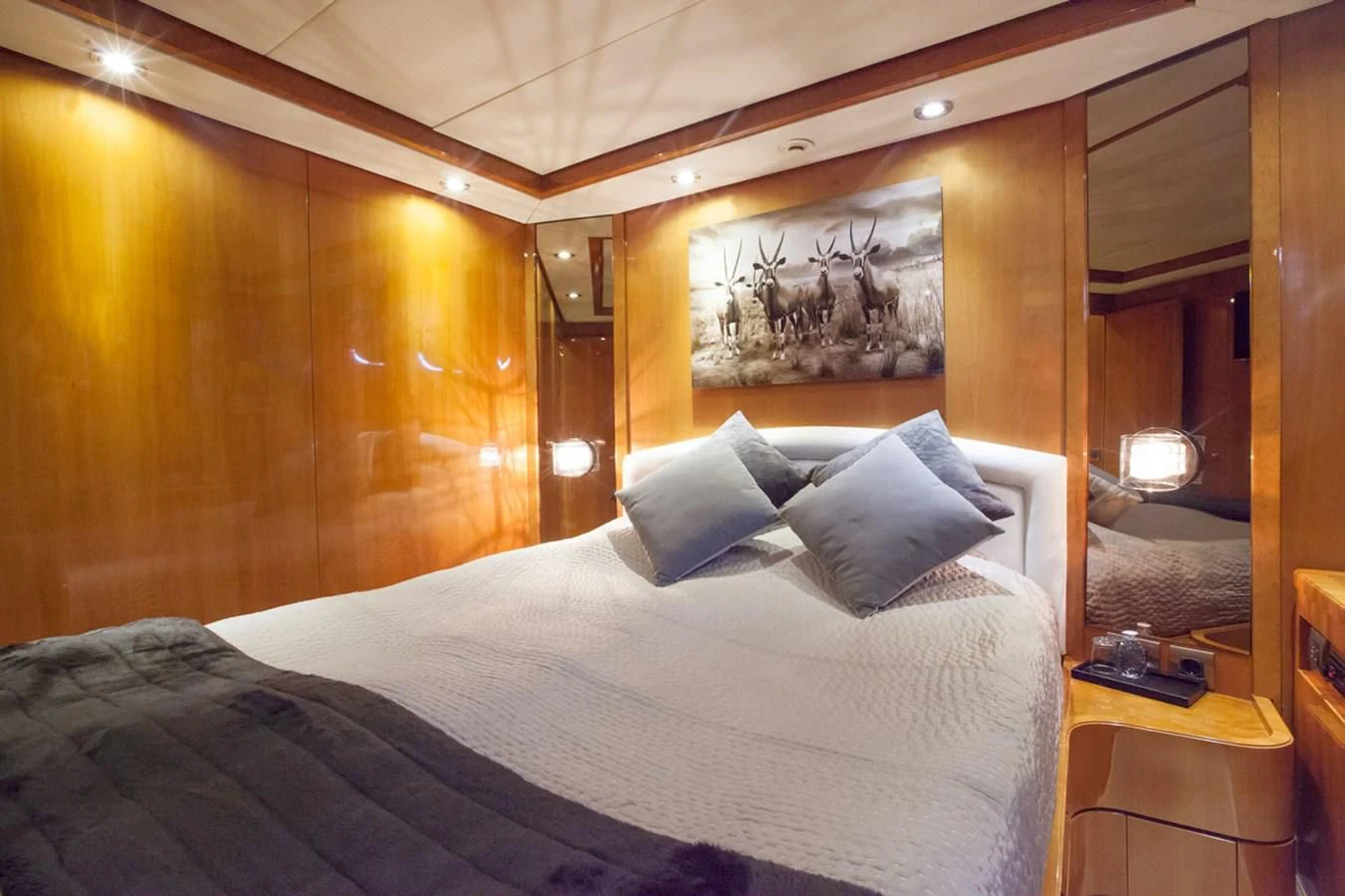 a bed with a white comforter aboard SOLAL Yacht for Sale