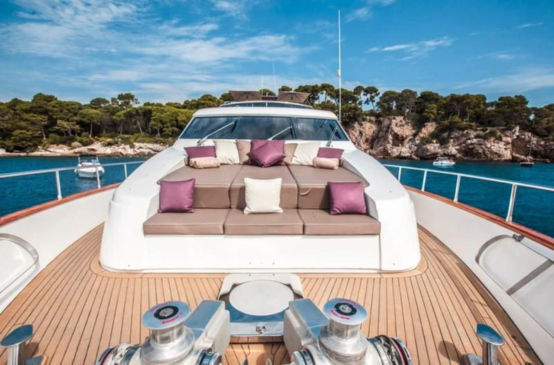 a white and pink lounge chair on a deck overlooking a body of water aboard SOLAL Yacht for Sale