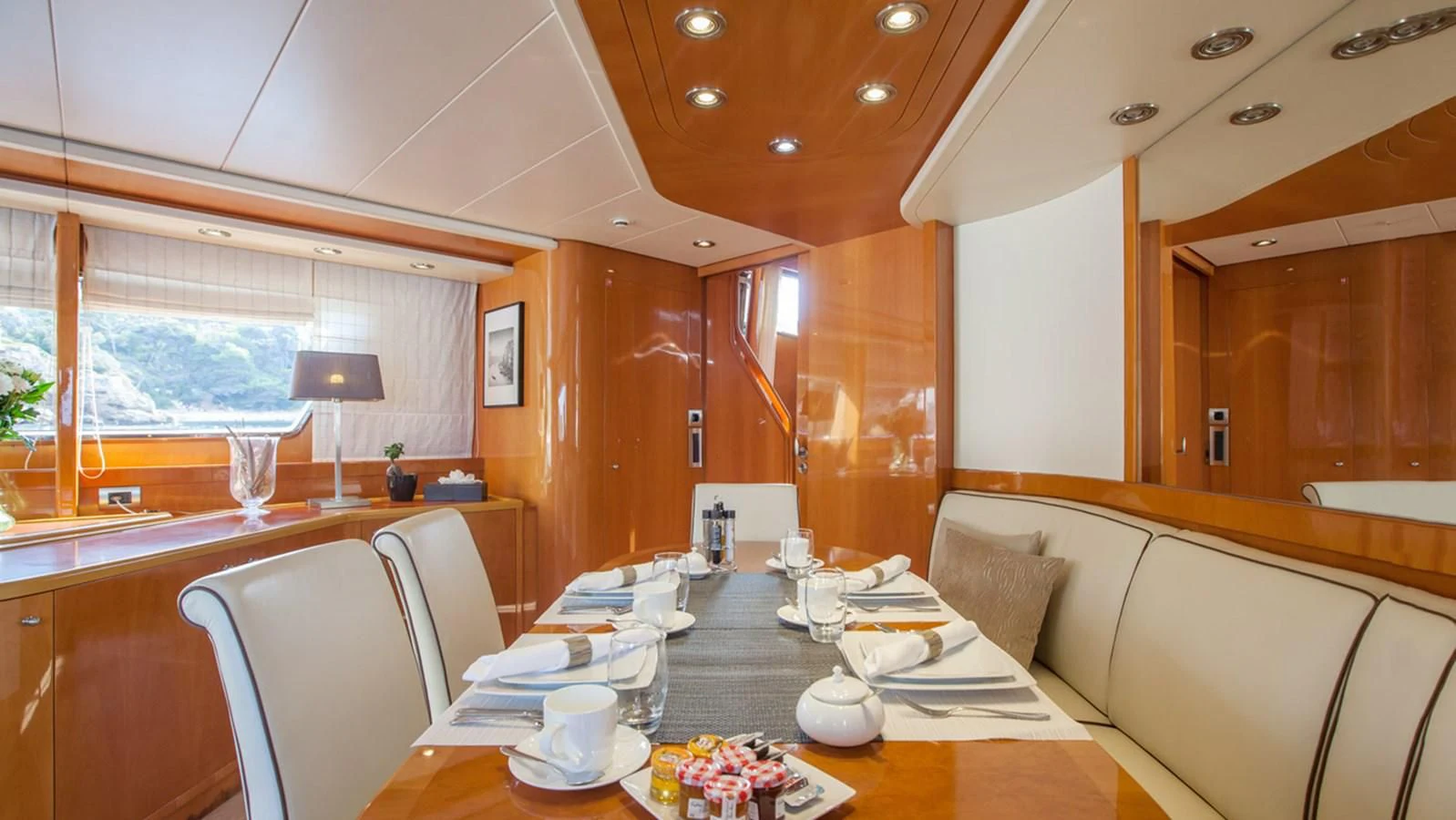 a room with a table and chairs aboard SOLAL Yacht for Sale