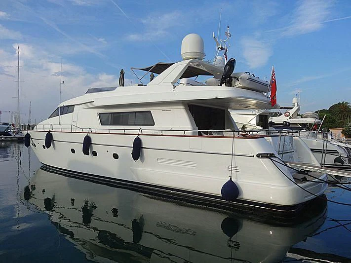 a white boat in a harbor aboard SOLAL Yacht for Sale