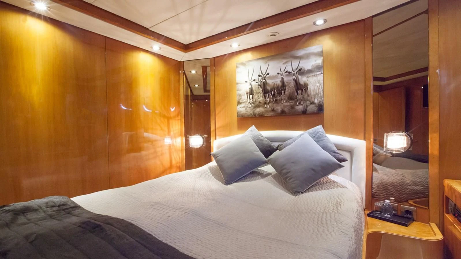 a bed with a white comforter and pillows aboard SOLAL Yacht for Sale