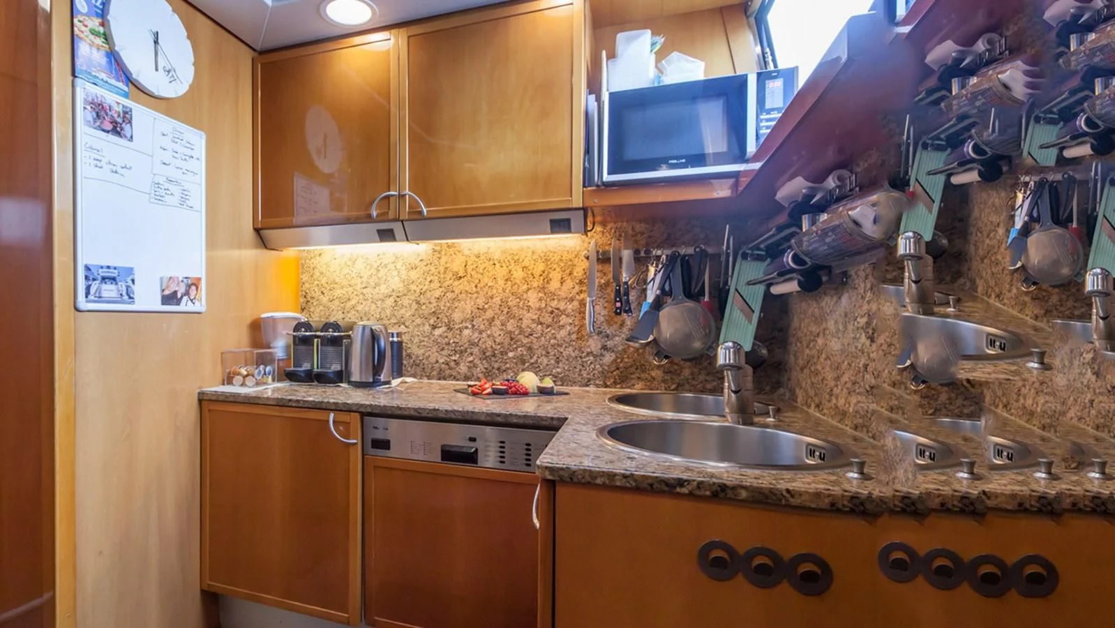 a kitchen with a sink and microwave aboard SOLAL Yacht for Sale