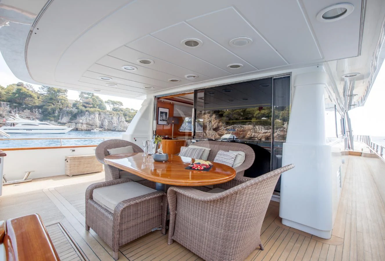 a table and chairs on a deck aboard SOLAL Yacht for Sale