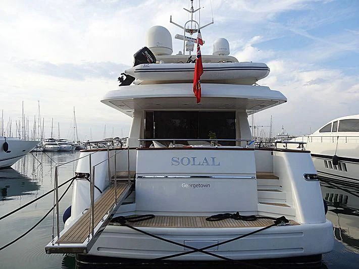 a large white boat with a red ribbon on the front aboard SOLAL Yacht for Sale