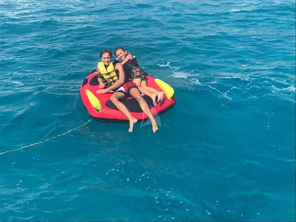 a group of people on a raft in the water aboard SOLAL Yacht for Sale