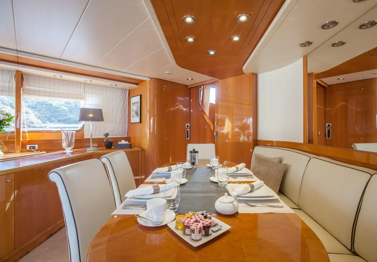 a table with plates and cups on it aboard SOLAL Yacht for Sale