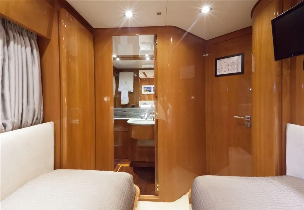 a room with a bed and a mirror aboard SOLAL Yacht for Sale