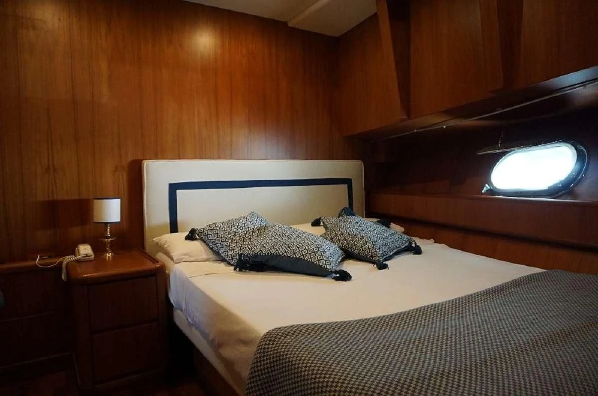a bed with a white bed spread aboard BALU 3 Yacht for Sale