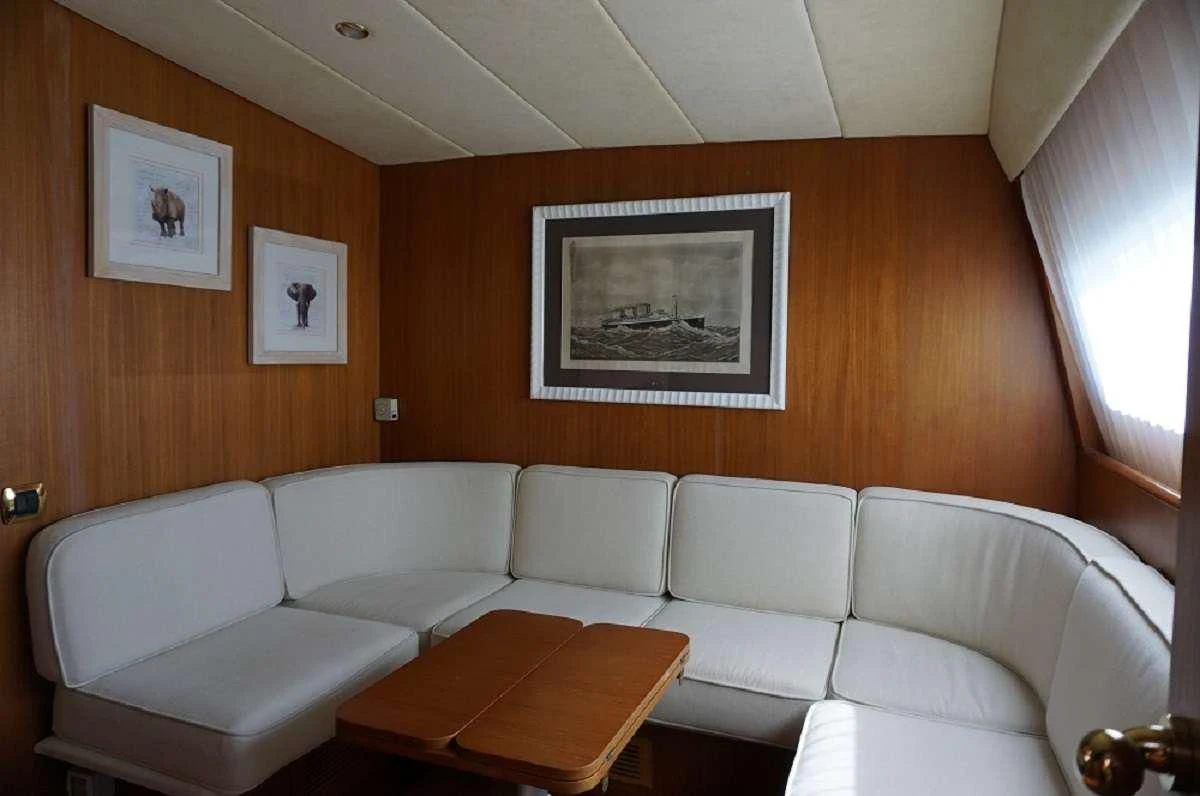 a living room with a couch and a table aboard BALU 3 Yacht for Sale