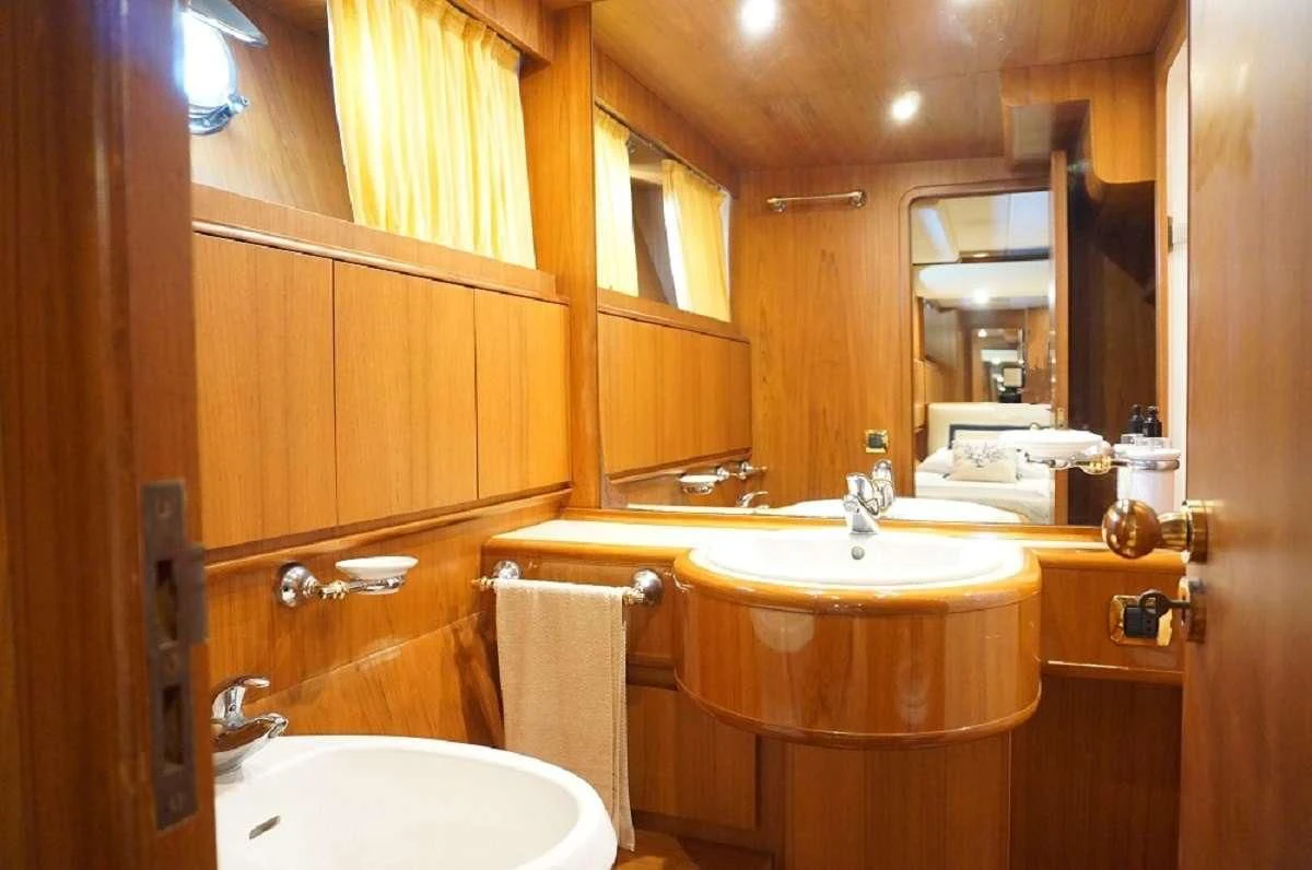 a bathroom with a sink and a mirror aboard BALU 3 Yacht for Sale