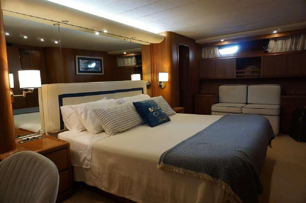a bed with a blue blanket aboard BALU 3 Yacht for Sale