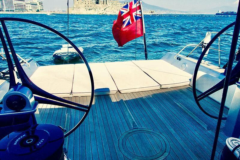 a boat with a flag on the front aboard MAGIC BLUE Yacht for Sale