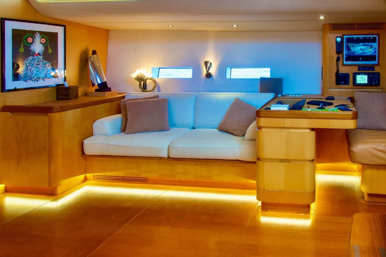 a living room with a couch and a tv aboard MAGIC BLUE Yacht for Sale