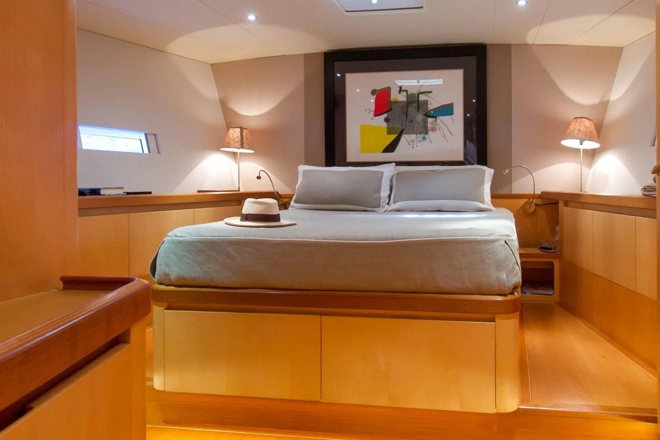 a bed with a television on the wall aboard MAGIC BLUE Yacht for Sale