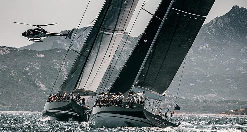 a helicopter flying over a boat aboard MAGIC BLUE Yacht for Sale