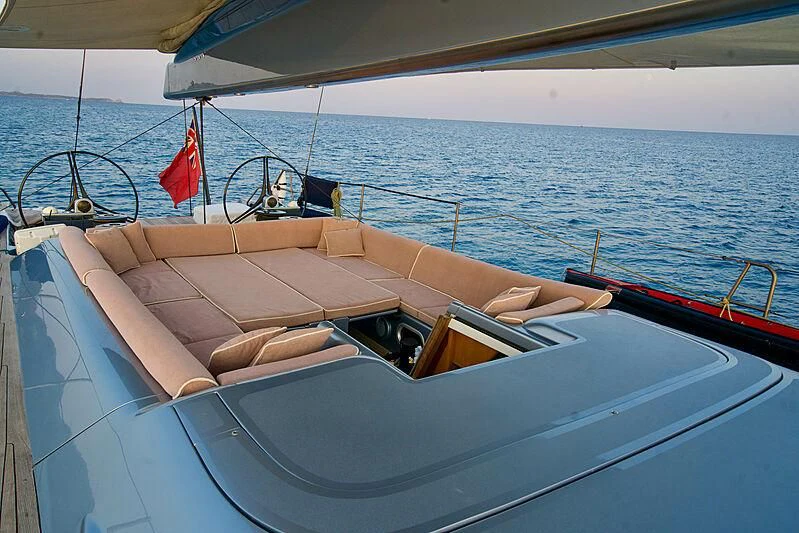 a boat with a red flag on the front aboard MAGIC BLUE Yacht for Sale