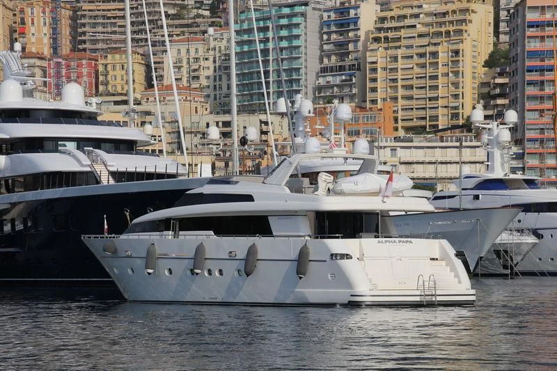 a group of boats sit in a harbor aboard ALPHA PAPA Yacht for Sale
