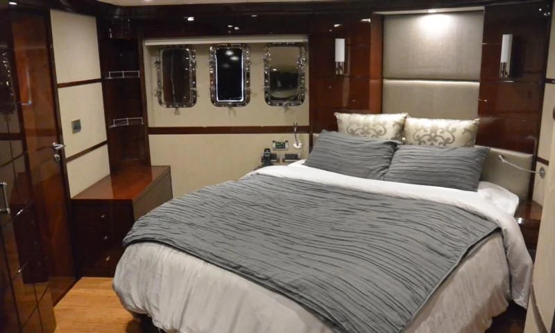 a bed with a white sheet aboard SERDAL Yacht for Sale