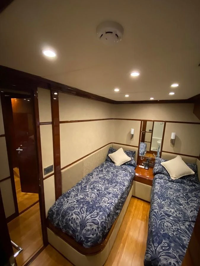a bedroom with a bed and a desk aboard SERDAL Yacht for Sale