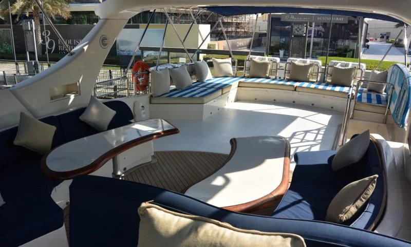 a boat with a table and chairs aboard SERDAL Yacht for Sale