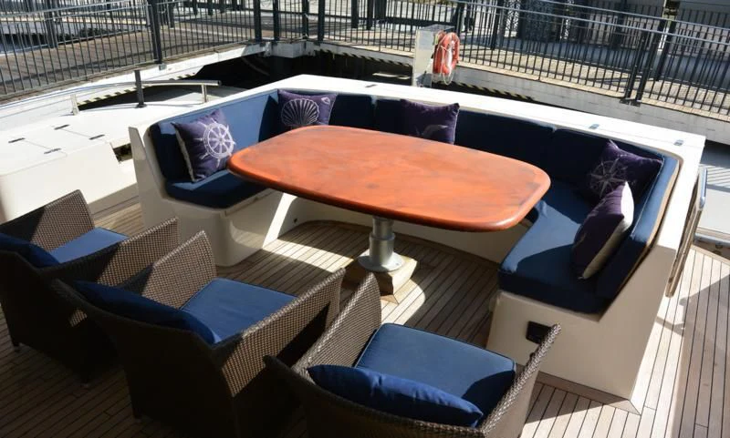 a table and chairs on a deck aboard SERDAL Yacht for Sale