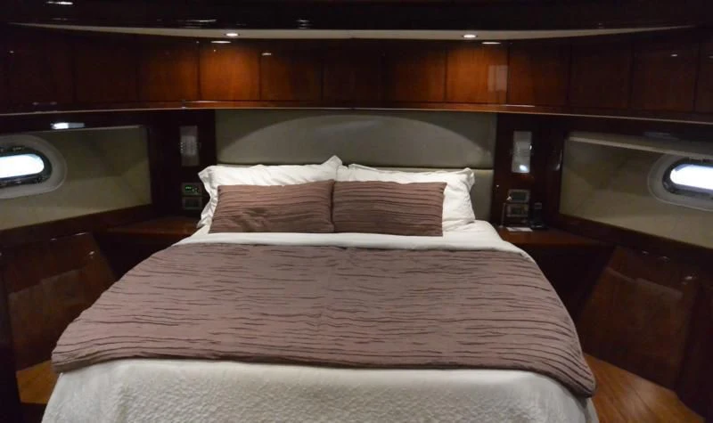a bed with a white comforter aboard SERDAL Yacht for Sale