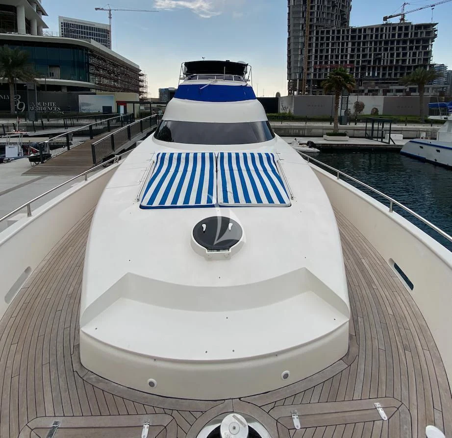 a white and blue boat on a dock by a body of water aboard SERDAL Yacht for Sale