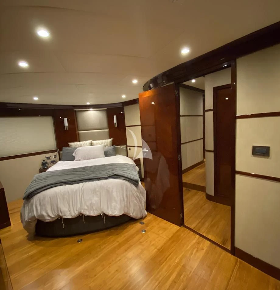 a bedroom with a wood floor aboard SERDAL Yacht for Sale