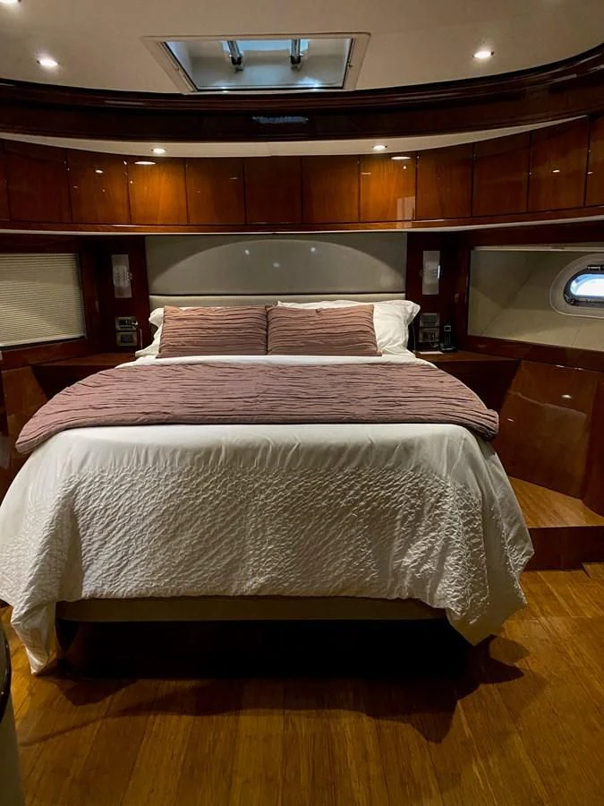 a bed with a white cover aboard SERDAL Yacht for Sale