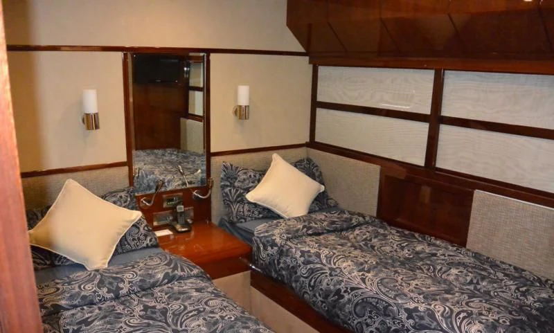 a hotel room with a bed and a mirror aboard SERDAL Yacht for Sale