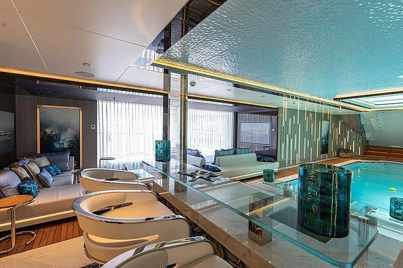 a living room with a large glass wall aboard TATIANA Yacht for Sale