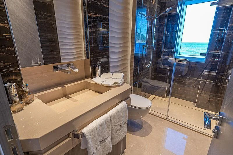 a bathroom with a glass shower aboard TATIANA Yacht for Sale