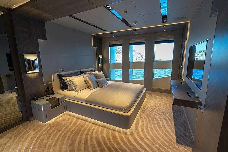 a bedroom with a bed and a tv aboard TATIANA Yacht for Sale