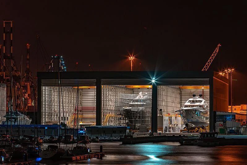 a large building with a bridge and a body of water in front of it aboard TATIANA Yacht for Sale
