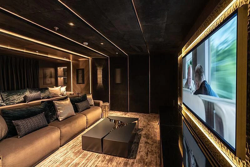 a living room with a large screen aboard TATIANA Yacht for Sale