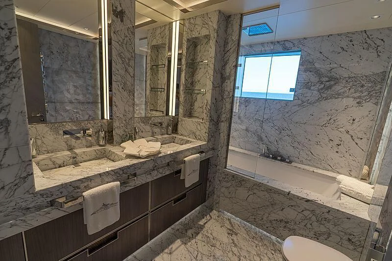 a bathroom with a large mirror aboard TATIANA Yacht for Sale