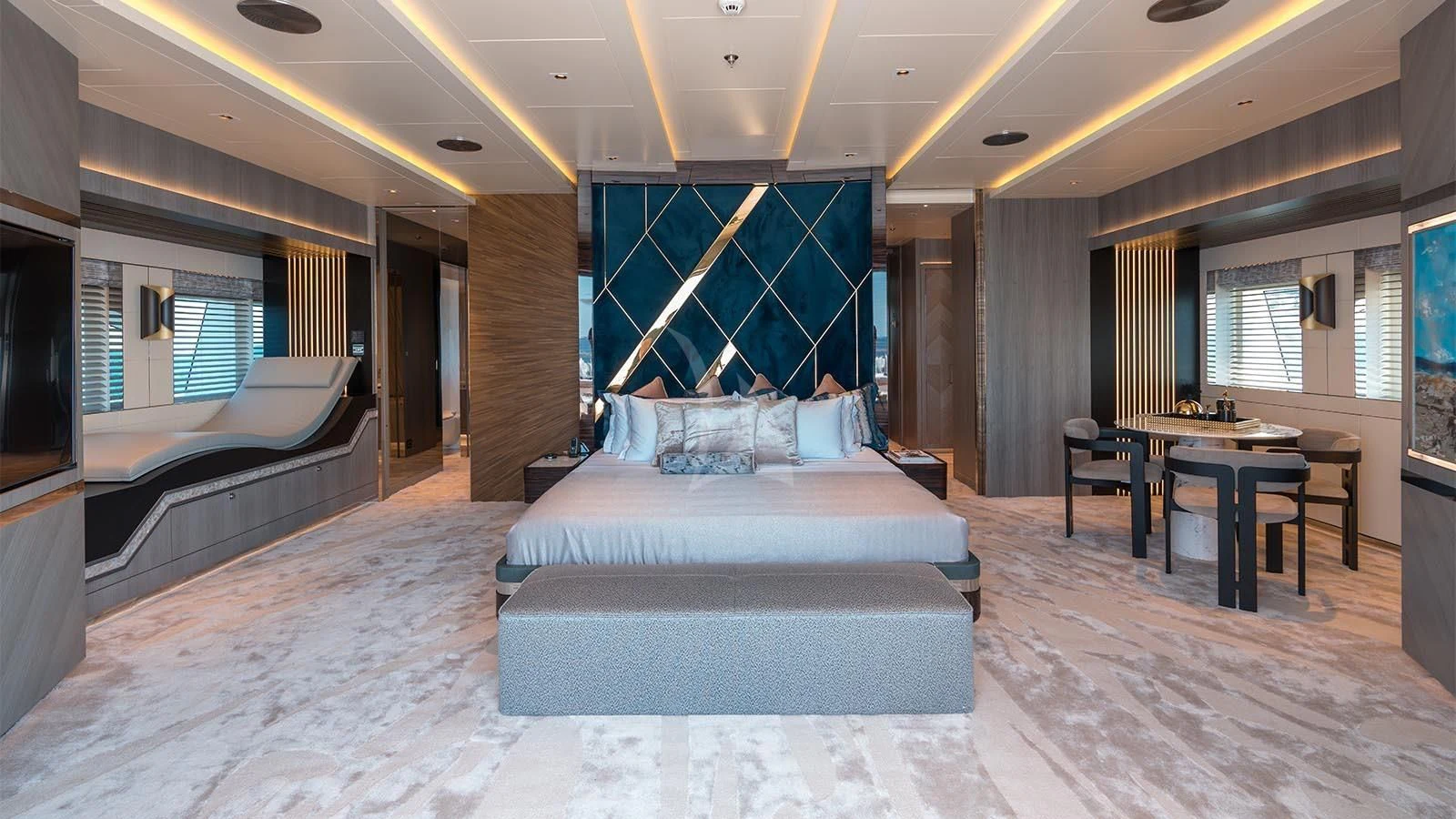 a large bedroom with a bed and desk aboard TATIANA Yacht for Sale
