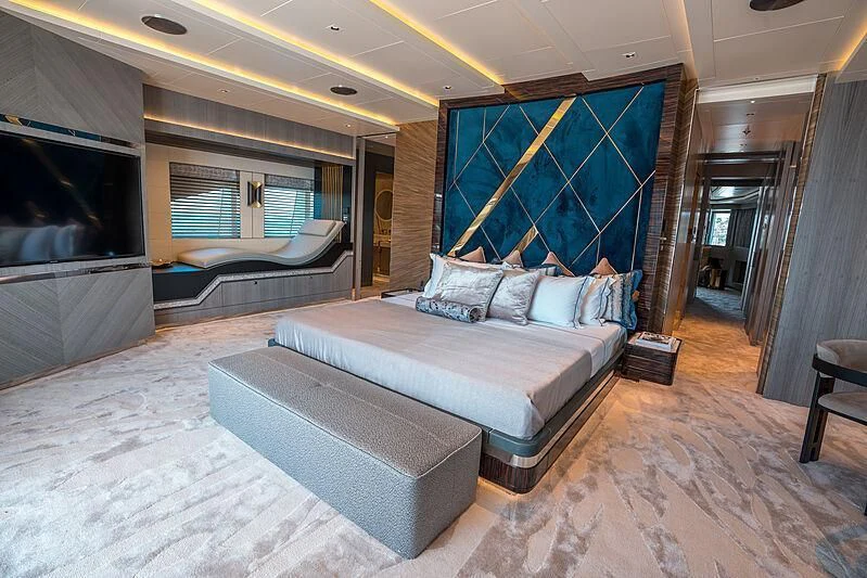 a bedroom with a large bed aboard TATIANA Yacht for Sale