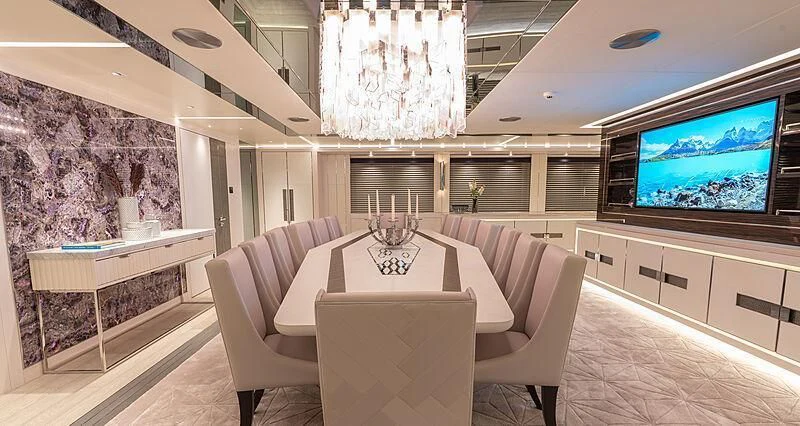 a room with a table and chairs aboard TATIANA Yacht for Sale