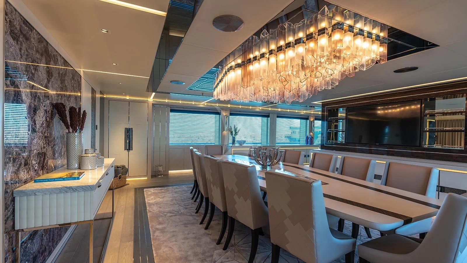 a room with a chandelier and chairs aboard TATIANA Yacht for Sale